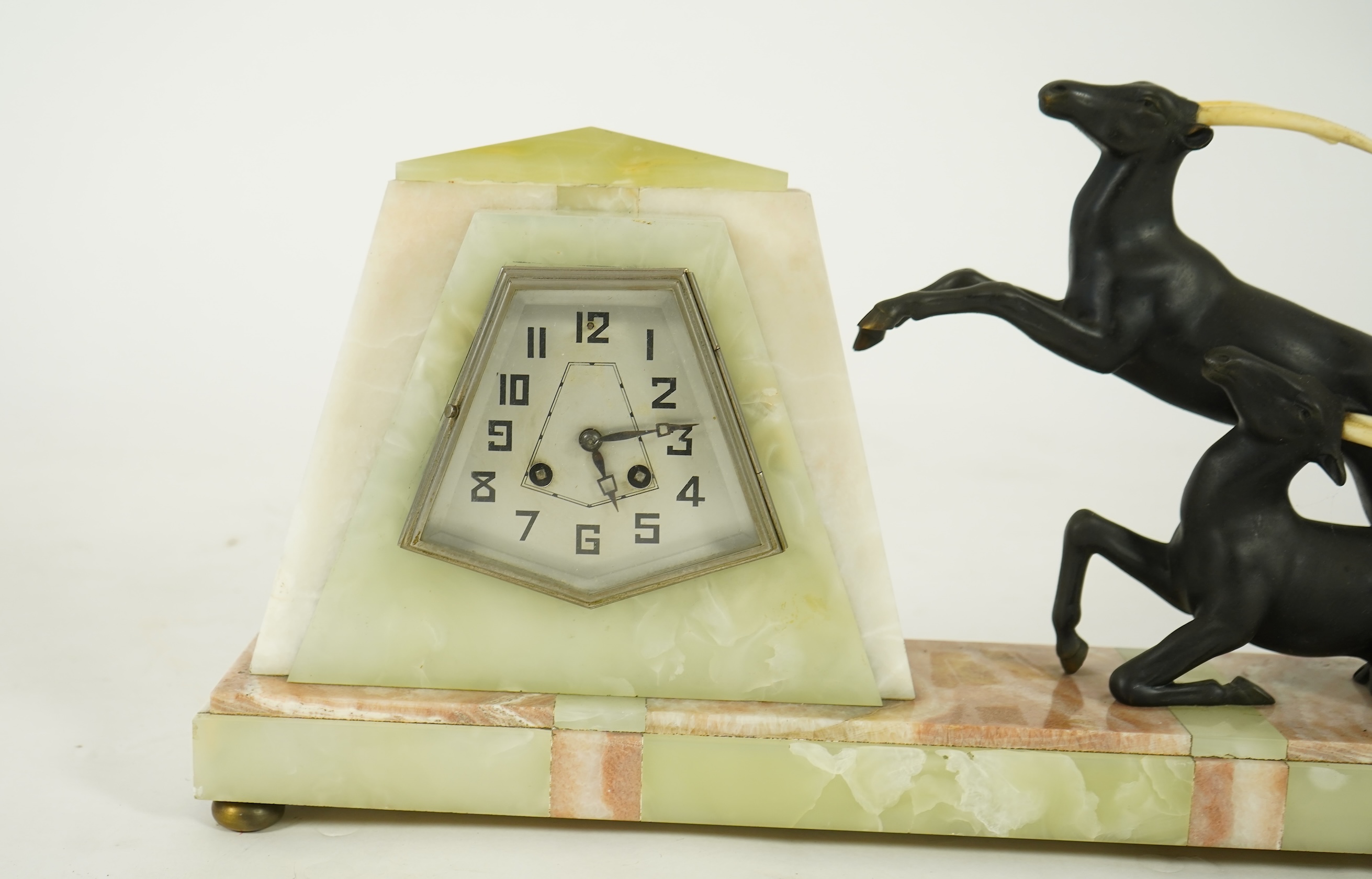 Attributed to Uriano (Ugo Cipriani, Italian, 1897-1960), a French green and cream onyx pyramid shaped clock